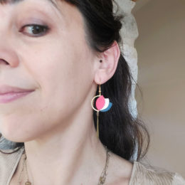 boucles d'oreilles colorées pendantes en cuir portées par une femme